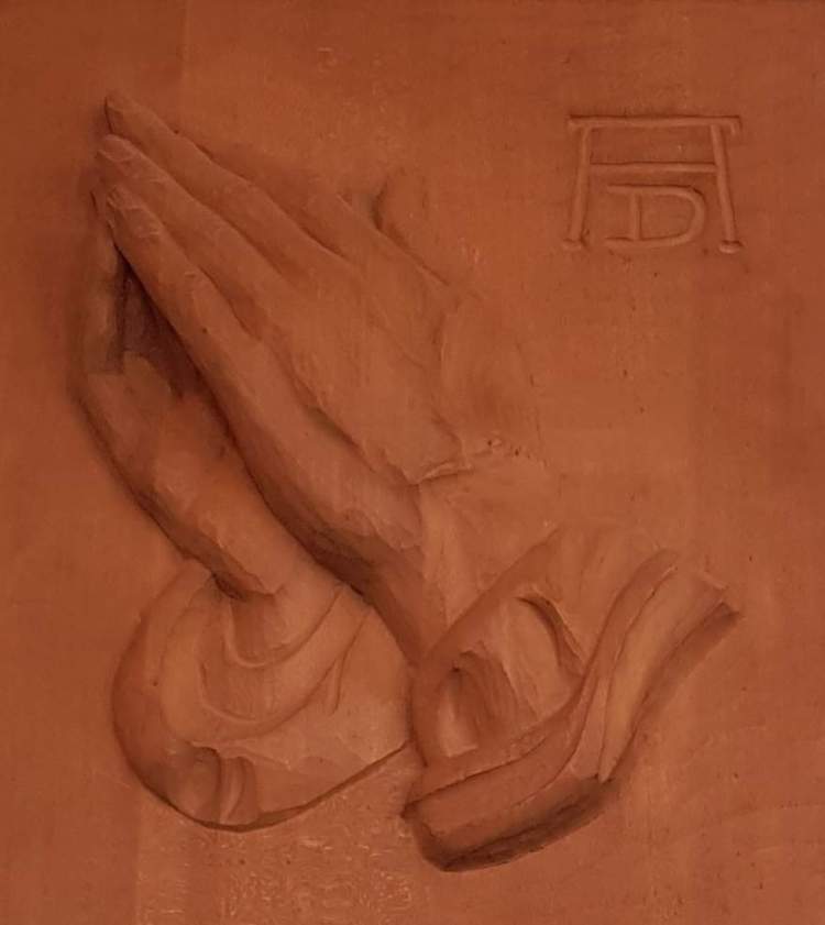 A clay relief of Albrect Durer's Praying Hands