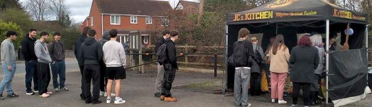 Wiltshire College students queue for food at the JC Kitchen stand in Upper Studley Baptist Church.
